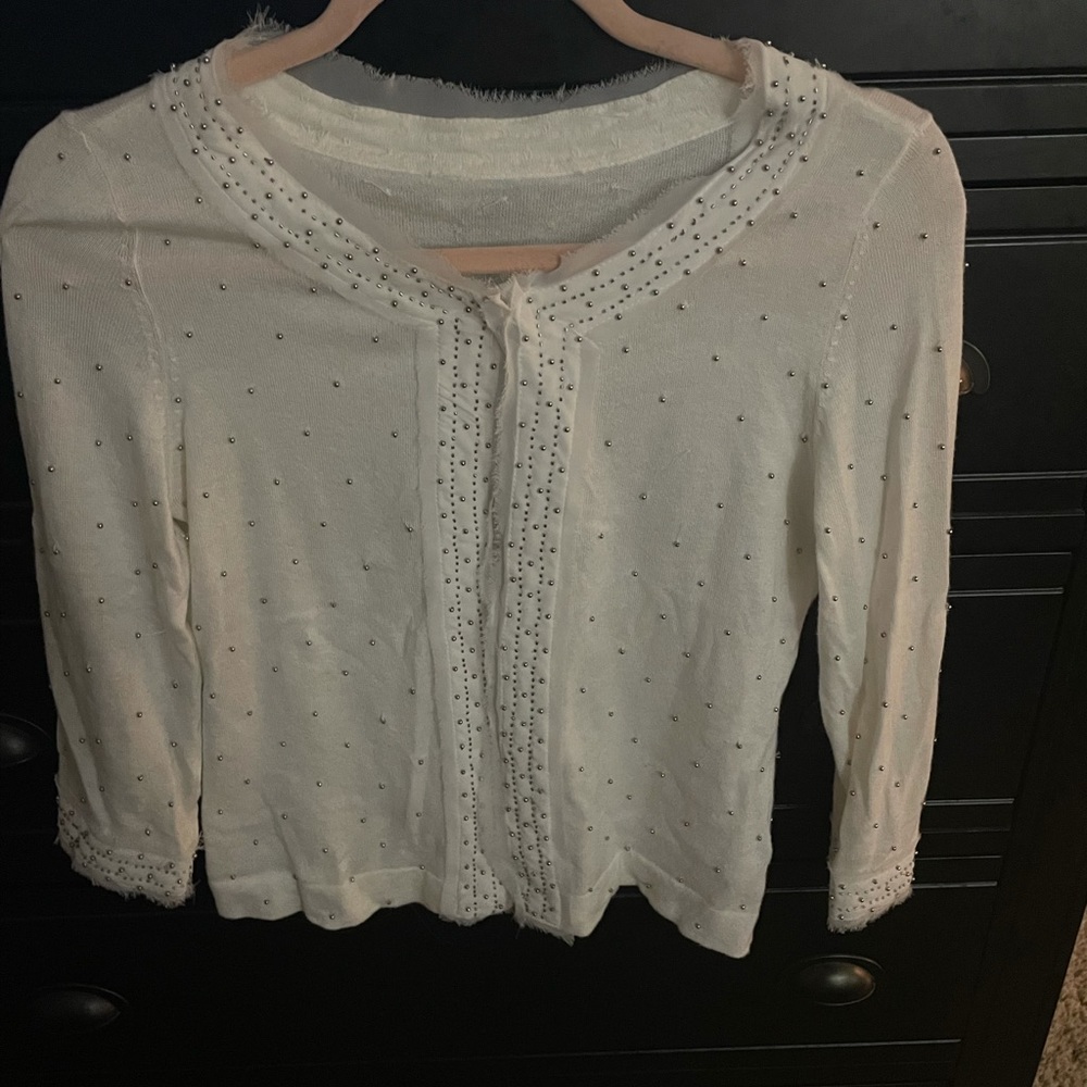 White cardigan light weight sweater with silver beading and sheer white trim.